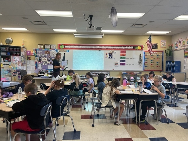 Mrs. Mowery reading a passage to her class, identifying key concepts and vocabulary words